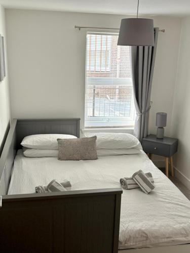 a bedroom with a bed with two slippers on it at Modern 2 bedroom Flat in Montrose in Montrose
