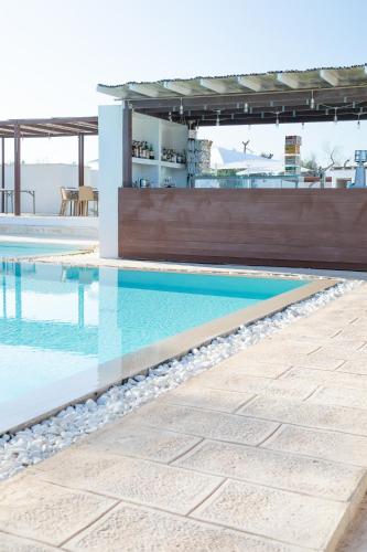 a swimming pool in a house with a building at Boomerang Village in Torre Colimena
