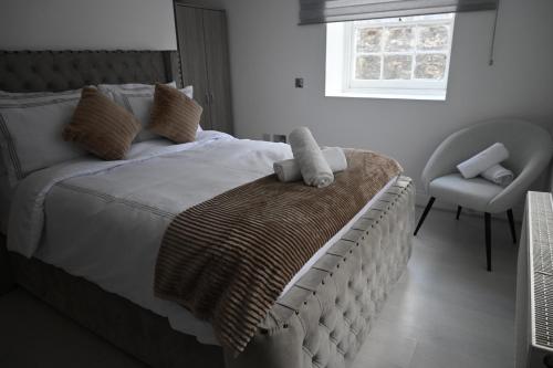a bedroom with a bed and a chair and a window at 2Bed Apartment-Free Parking Pets Garden Central in London