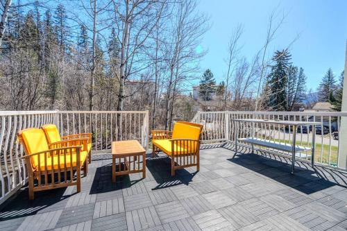 a group of chairs and a table on a deck at The Riverside Retreat at Fairmont in Fairmont Hot Springs