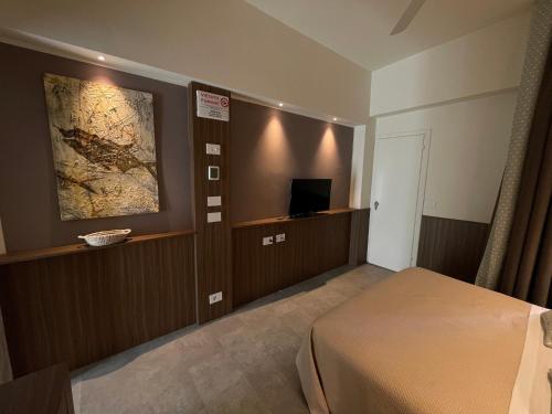 a hotel room with a bed and a television at Hotel Everest - Bar e Ristorante in Gabicce Mare