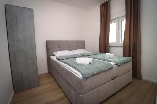 a bedroom with a bed with two towels on it at Kuća za odmor Ana in Prozor
