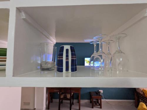 a shelf with several glass vases on it at Nairobi bliss haven in Nairobi