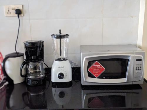 a microwave and a blender sitting on a counter at Nairobi bliss haven in Nairobi