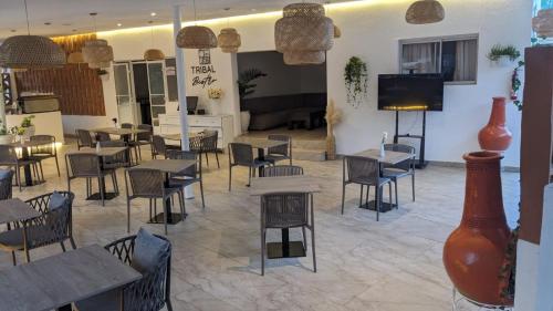 a restaurant with tables and chairs and a flat screen tv at Nairobi bliss haven in Nairobi