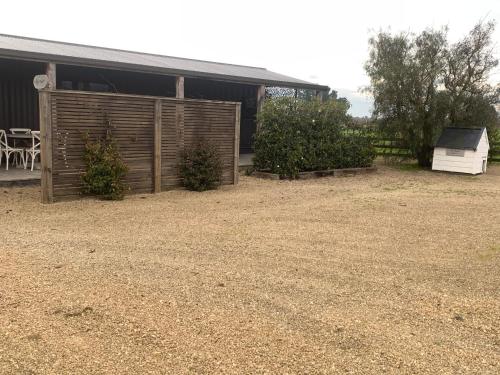 a house with a yard with a shed and a table at Bellevue Haven in Masterton