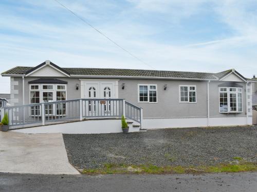 a large house with a large deck at Eryl Mor Lodge in Amlwch