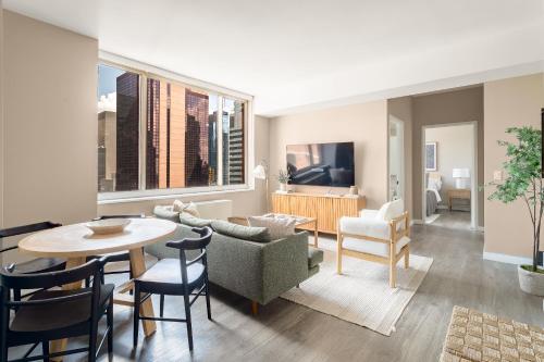 a living room with a table and chairs at Chic NYC Stay Steps from Times Square with 2 bedroom in New York