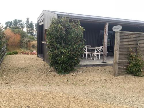 a garden with a table and chairs on a patio at Bellevue Haven in Masterton