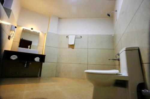 a bathroom with a toilet and a sink at The Nalanda Boho in Leh