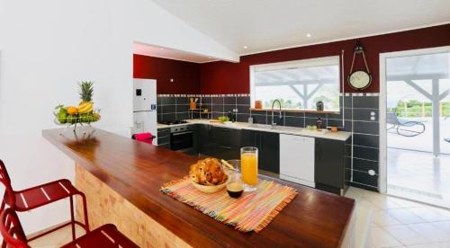 a kitchen with a table with a bowl of food on it at Magnifique villa piscine vue mer à 180 in Sainte-Anne
