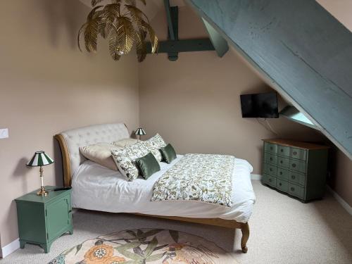 a bedroom with a bed and a blue staircase at Domaine du Turbais in Luynes