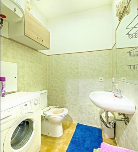 a bathroom with a washing machine and a sink at Best location Old Town Choise in Vilnius