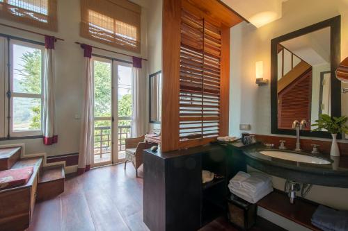 a bathroom with a sink and a mirror at The Belle Rive Boutique Hotel in Luang Prabang