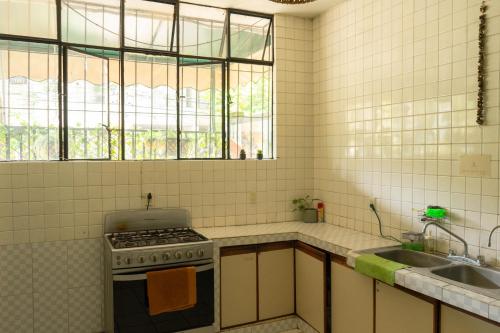 a kitchen with a stove and a sink at Casa Sabina in Guadalajara