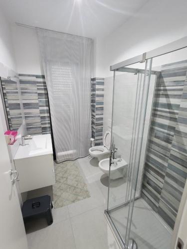 a bathroom with a shower and a toilet and a sink at Wolfy's Apartment in San Benedetto del Tronto