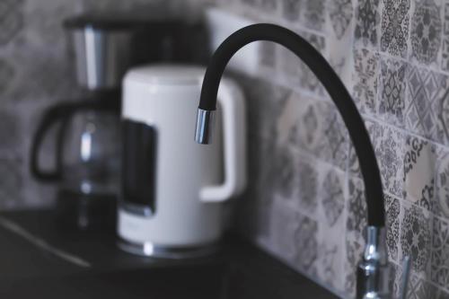 a coffee pot sitting on a counter next to aaucet at Apartment Simply 205 in Gázion
