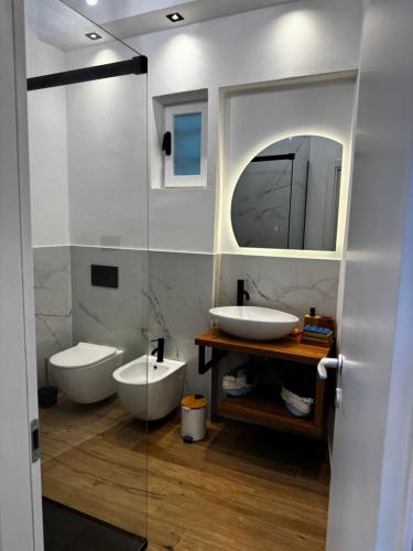 a bathroom with two sinks and a mirror at La Casetta di Riccardo - Terrace Sea View in Portovenere