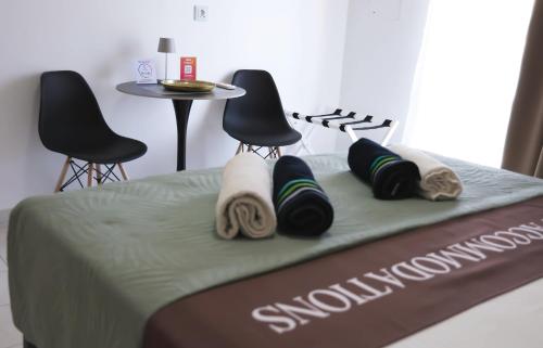 a close up of a bed with towels on it at Apartment Simply 205 in Gázion
