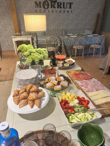 a table with plates of food on top at Hotel Boutique Moli El Canyisset in Gandía