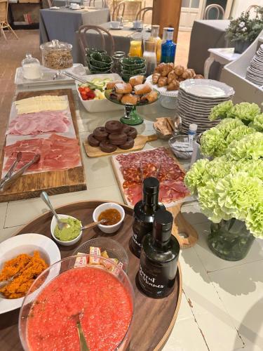 a table topped with lots of different types of food at Hotel Boutique Moli El Canyisset in Gandía