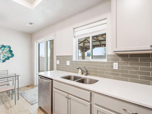 a kitchen with a sink and a window at Heart of Nampa-Hot Tub-Fenced Yard-Full Kitchen in Nampa