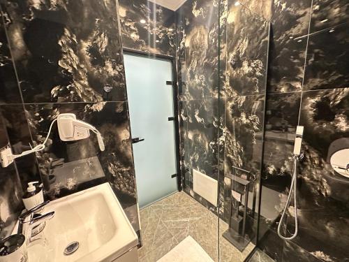 a bathroom with a sink and a shower at LiEl Holiday in Vlorë