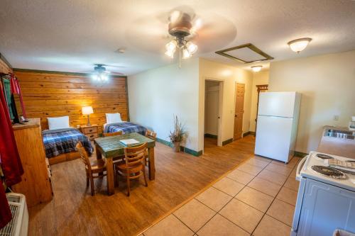 a kitchen and dining room with a table and a refrigerator at Fishtale Lodge Cabins in Buchanan
