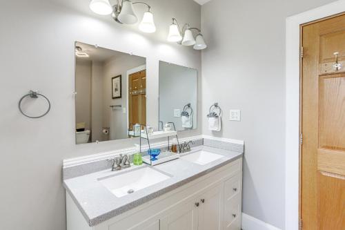 a bathroom with a sink and a large mirror at 1 Mi to Water and Dtwn Lake Erie Family Getaway in Sandusky