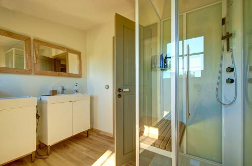 a bathroom with a shower and a sink at Kuliniai by Stirniai lake Moletai district in Kulintse