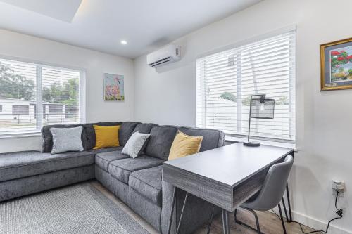 a living room with a couch and a table at 8 Mi to Design District Miami Home with Yard in Miami