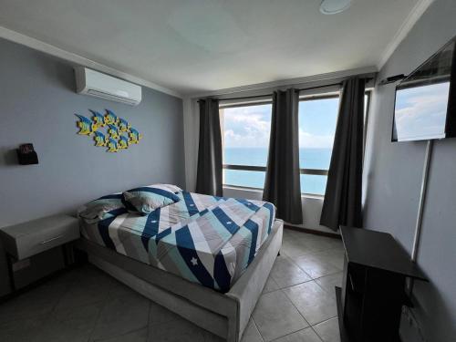 a bedroom with a bed with a view of the ocean at Alojamiento Peñón del rodadero in Santa Marta