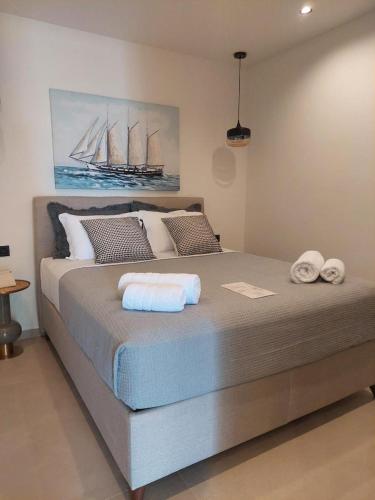 a bedroom with a large bed with towels on it at MiLiON RESIDENCES in Parga
