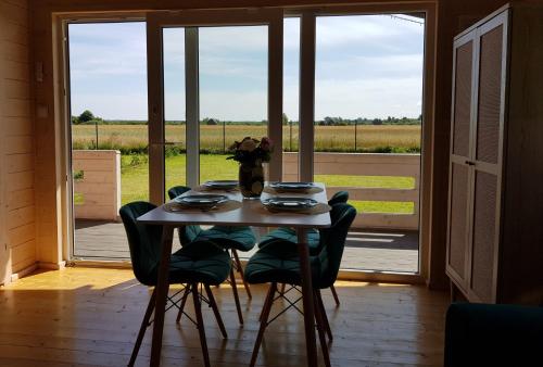 a table and chairs in a room with a window at BohoWicko in Jezierzany