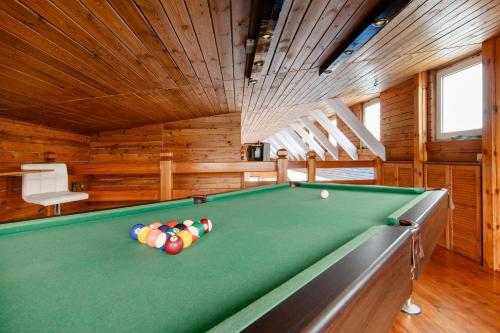 a pool table in a room with wooden walls at Dom49 
