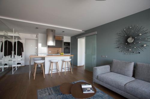 a living room and kitchen with a couch and a table at Angel in Druskininkai