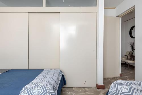 a bedroom with white walls and a bed at Acogedor departamento, centro histórico Monterrey in Monterrey