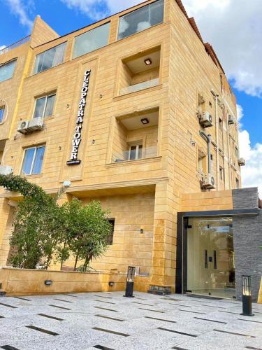 a tall building with a large window at Cleo Patra Pyramids Tower Inn in Banī Ghālib