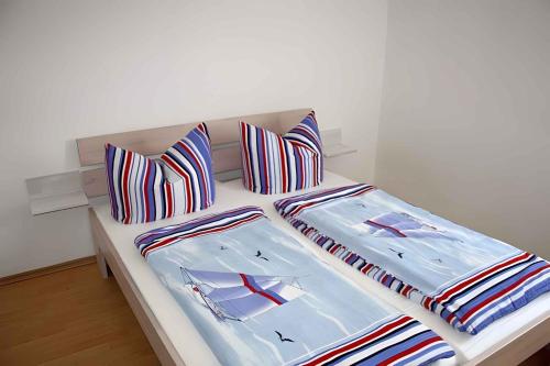 two beds with colorful pillows on them in a room at One-Bedroom Apartment in Putbus I in Putbus