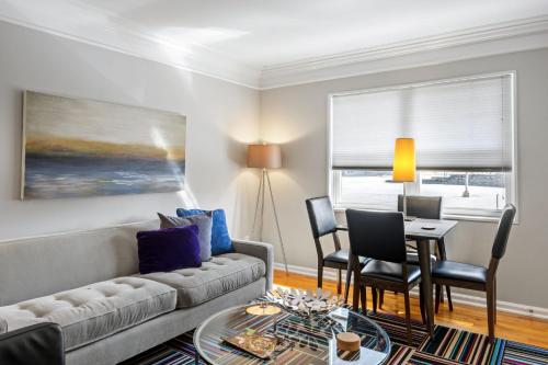 a living room with a couch and a table and chairs at Brookwood Courtyard by BCA Furnished Apartments in Atlanta