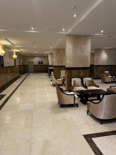 a large lobby with couches and tables and chairs at ذا جولد للشقق المخدومة in Jeddah