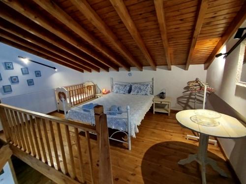 a bedroom with a bed with a wooden ceiling at dilemi 3 in Tavari