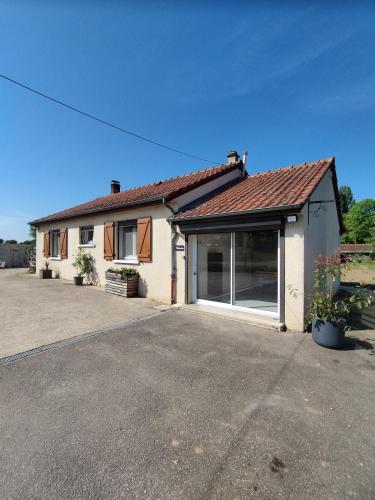 a house with a large window and a garage at Partout l'étang Montier en der in La Bouverie