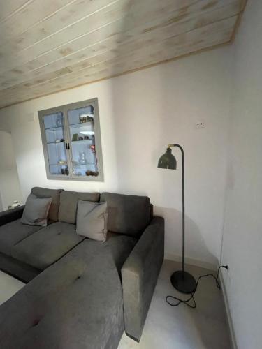 a living room with a couch and a lamp at Casa Ferrero Salvador in Bolea
