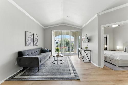 a living room with a couch and a bed at The Calvin Spacious 334 I 2 Bed 1 Bath in Plano