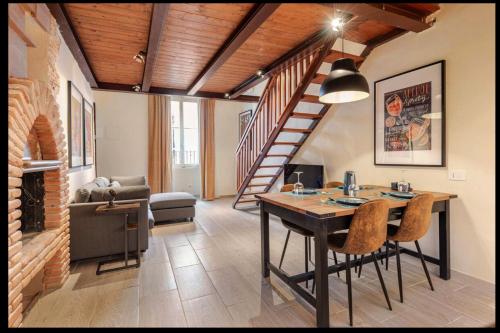 a living room with a table and a staircase at Spoleto between past, art, music in Spoleto