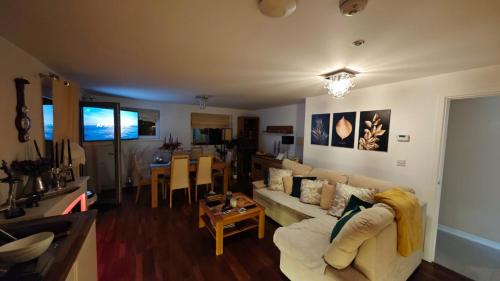 a living room with a couch and a table at The Bridge in Dartford