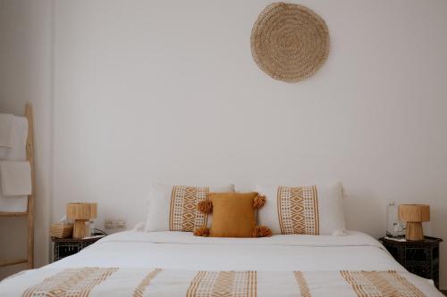 a bedroom with a large white bed with pillows at Riad Searenity in Tamraght Ouzdar