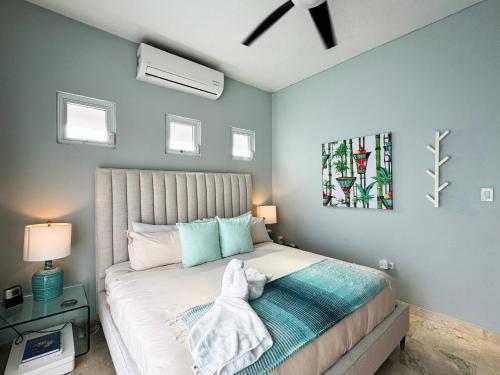 a bedroom with a white dog laying on a bed at Condado Laguna Villa w Pool 5 Bd 3 Ba - Generator in San Juan