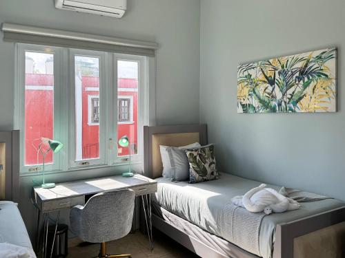 a bedroom with a bed and a desk and a window at Condado Laguna Villa w Pool 5 Bd 3 Ba - Generator in San Juan